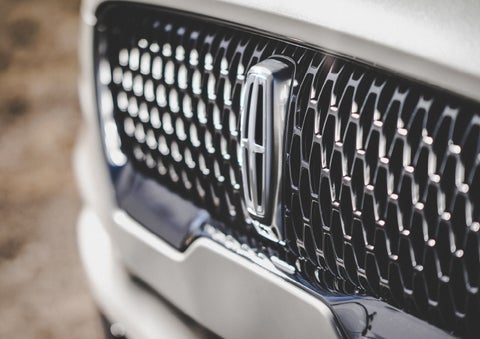 The grille of the 2024 Lincoln Aviator® Reserve model with an eye-catching repeated field of Lincoln Star logo shapes | Apple Lincoln Apple Valley in Apple Valley MN