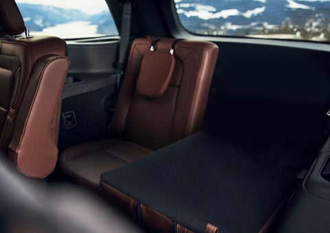The left rear seat of a 2024 Lincoln Aviator® SUV is shown folded flat for additional cargo space | Apple Lincoln Apple Valley in Apple Valley MN