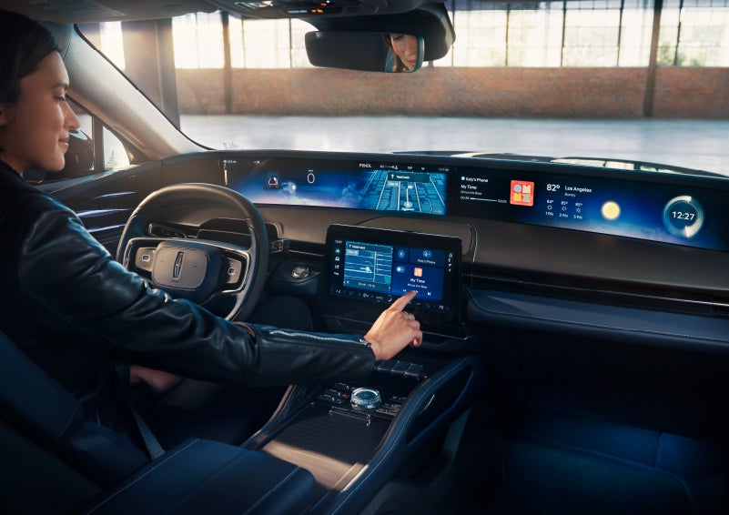 The driver of a 2024 Lincoln Nautilus® SUV interacts with the center touchscreen. | Apple Lincoln Apple Valley in Apple Valley MN