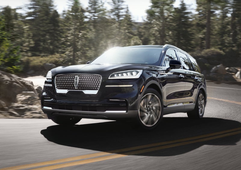 A Lincoln Aviator® SUV is being driven on a winding mountain road | Apple Lincoln Apple Valley in Apple Valley MN