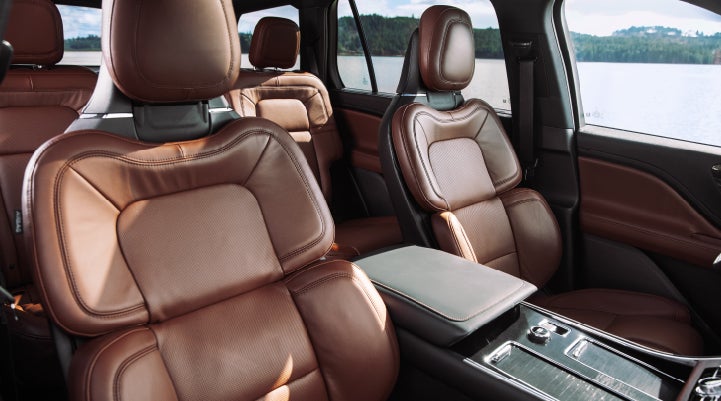 The front row's Perfect Position Seats in a 2024 Lincoln Aviator® Reserve model with Ebony Roast interior | Apple Lincoln Apple Valley in Apple Valley MN