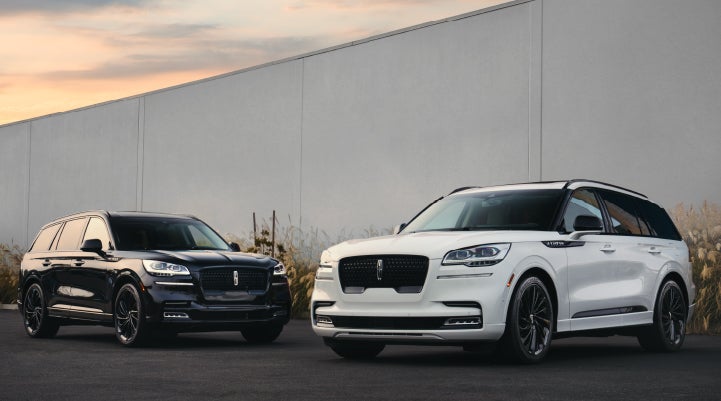 Two Lincoln Aviator® SUVs are shown with the available Jet Appearance Package | Apple Lincoln Apple Valley in Apple Valley MN