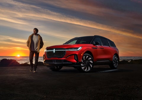 A person is shown next to a 2024 Lincoln Nautilus® SUV as the Lincoln Embrace sequence takes place. | Apple Lincoln Apple Valley in Apple Valley MN