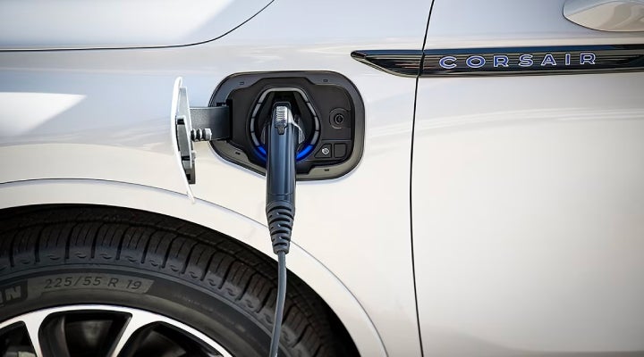 An electric charger is shown plugged into the charging port of a Lincoln Corsair® Grand Touring
model. | Apple Lincoln Apple Valley in Apple Valley MN
