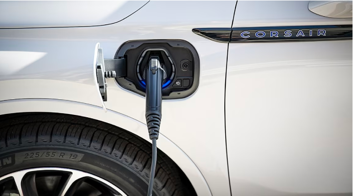 An electric charger is shown plugged into the charging port of a Lincoln Corsair® Grand Touring
model. | Apple Lincoln Apple Valley in Apple Valley MN