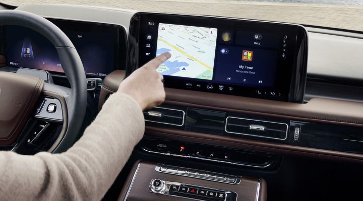 A person is tapping the center display touchscreen of a 2026 Lincoln Aviator® SUV. | Apple Lincoln Apple Valley in Apple Valley MN