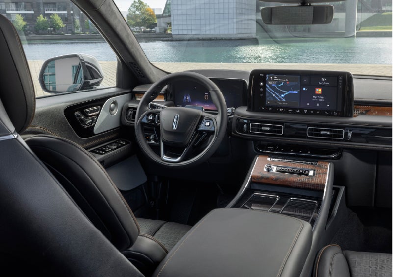 The interior of the 2026 Lincoln Aviator® SUV is shown parked with a view of a harbor through the windshield. | Apple Lincoln Apple Valley in Apple Valley MN