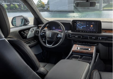 The interior of the 2026 Lincoln Aviator® SUV is shown parked with a view of a harbor through the windshield. | Apple Lincoln Apple Valley in Apple Valley MN