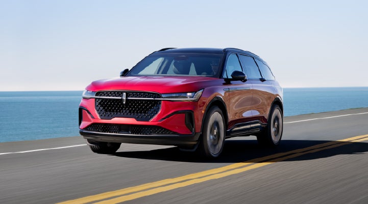 A 2026 Lincoln Nautilus® SUV is being driven on a seaside roadway. | Apple Lincoln Apple Valley in Apple Valley MN