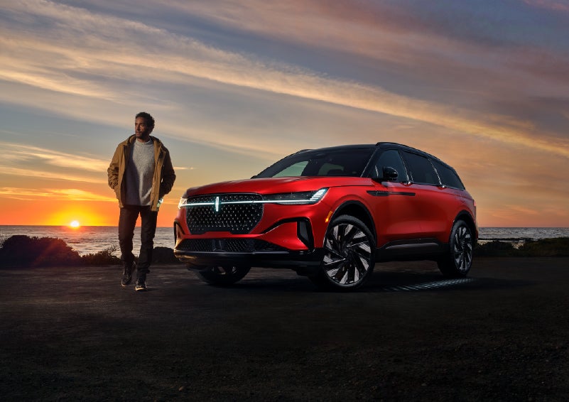A person is shown next to a 2026 Lincoln Nautilus® SUV as the Lincoln Embrace sequence takes place. | Apple Lincoln Apple Valley in Apple Valley MN