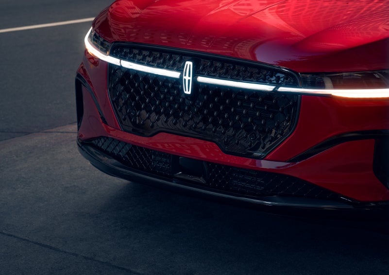 The available front LED light bar and center Lincoln Star logo glow at dusk. | Apple Lincoln Apple Valley in Apple Valley MN