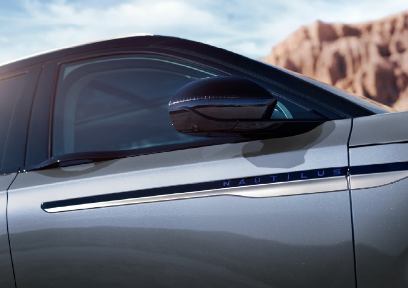 Blue lettering on the side of the vehicle that reads Nautilus indicates the available Hybrid Powertrain. | Apple Lincoln Apple Valley in Apple Valley MN