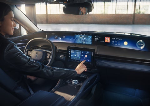 The driver of a 2026 Lincoln Nautilus® SUV interacts with the center touchscreen. | Apple Lincoln Apple Valley in Apple Valley MN
