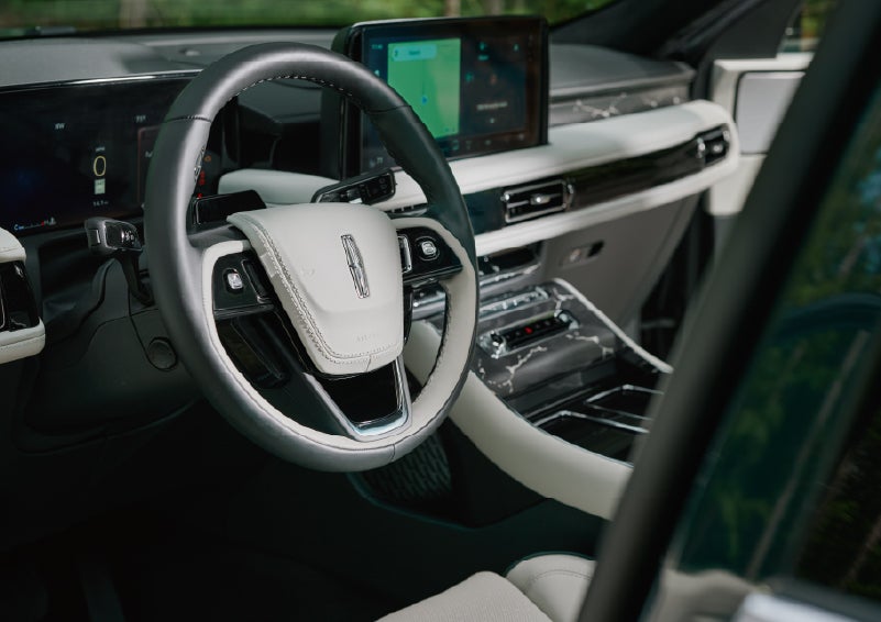 The leather-trimmed steering wheel of a 2027 Lincoln Aviator® Black Label™ SUV. | Apple Lincoln Apple Valley in Apple Valley MN