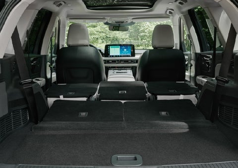 A rear to front view of the interior of a 2027 Lincoln Aviator® Black Label™ SUV shows the third and second rows folded flat | Apple Lincoln Apple Valley in Apple Valley MN