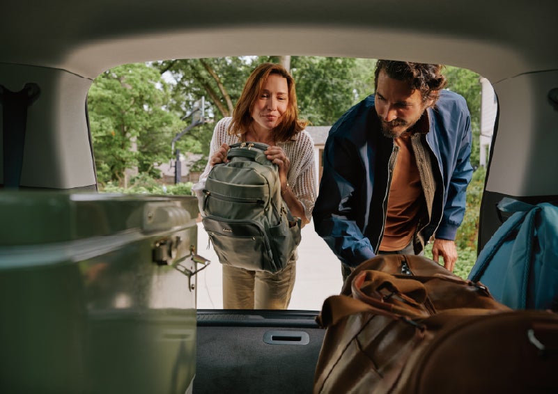 A couple loads luggage into the rear of a 2027 Lincoln Aviator® Black Label™ SUV..e 202 | Apple Lincoln Apple Valley in Apple Valley MN