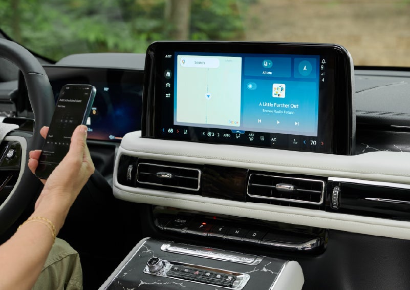 A person pairs thier phone with the center touchscreen of a 2027 Lincoln Aviator® Black Label™ SUV | Apple Lincoln Apple Valley in Apple Valley MN